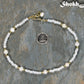 Freshwater Pearl and White Seed Bead Choker Necklace with Gold Plated Spacers beside a dime.