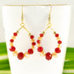 Close up of Red and Gold Glass Crystal Hoop Earrings.