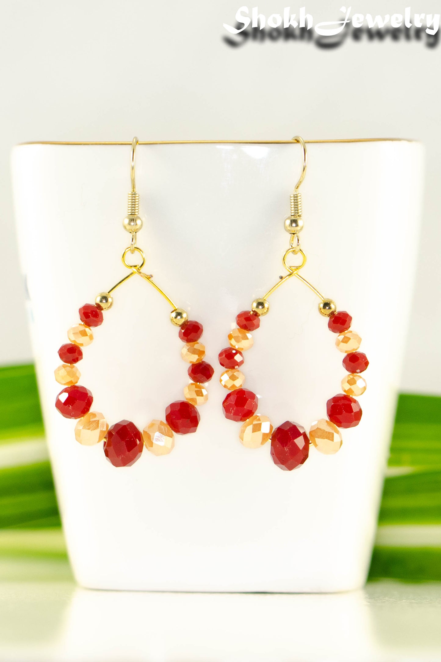 Close up of Red and Gold Glass Crystal Hoop Earrings.