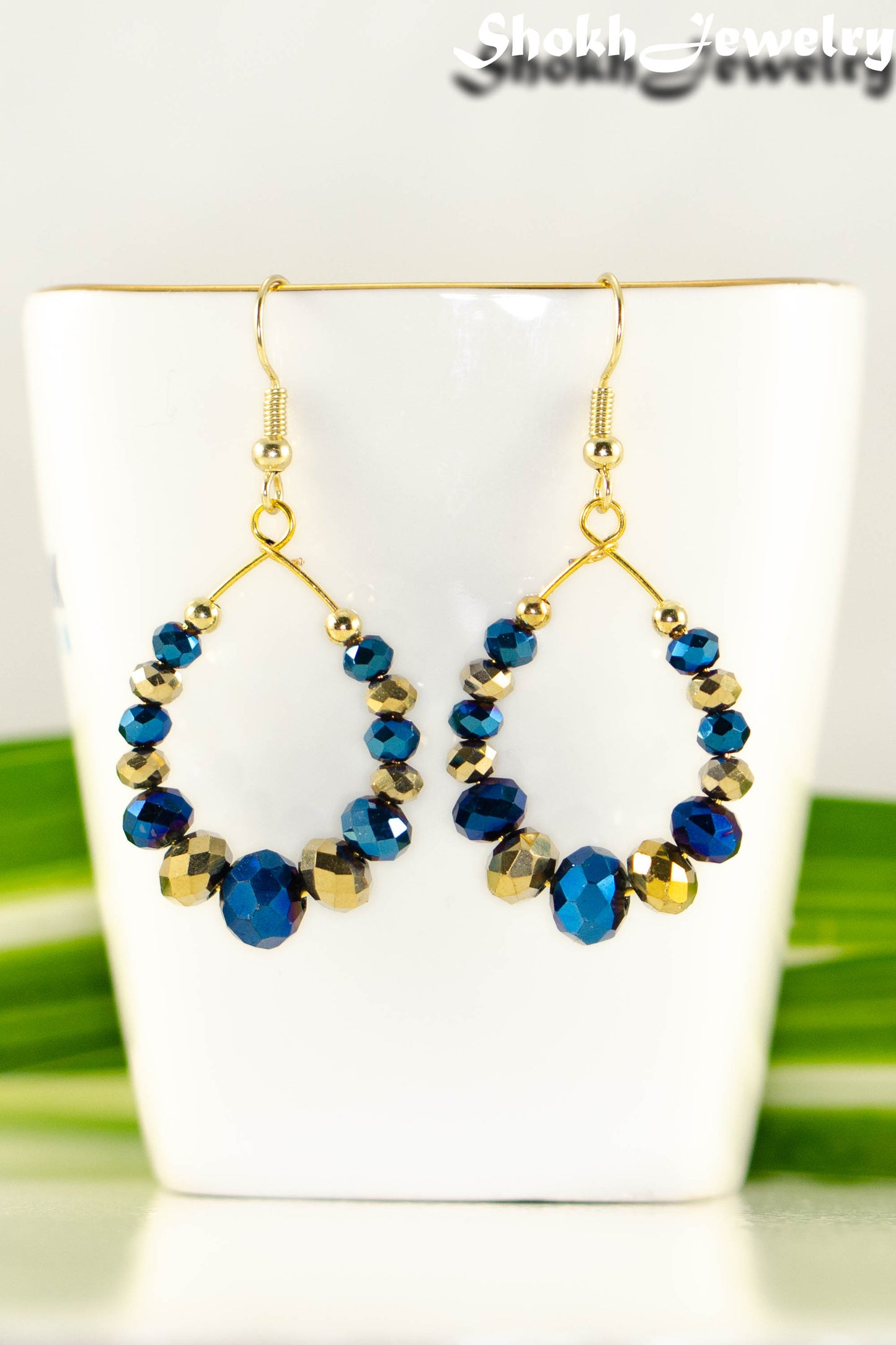 Close up of Blue and Gold Glass Crystal Hoop Earrings.