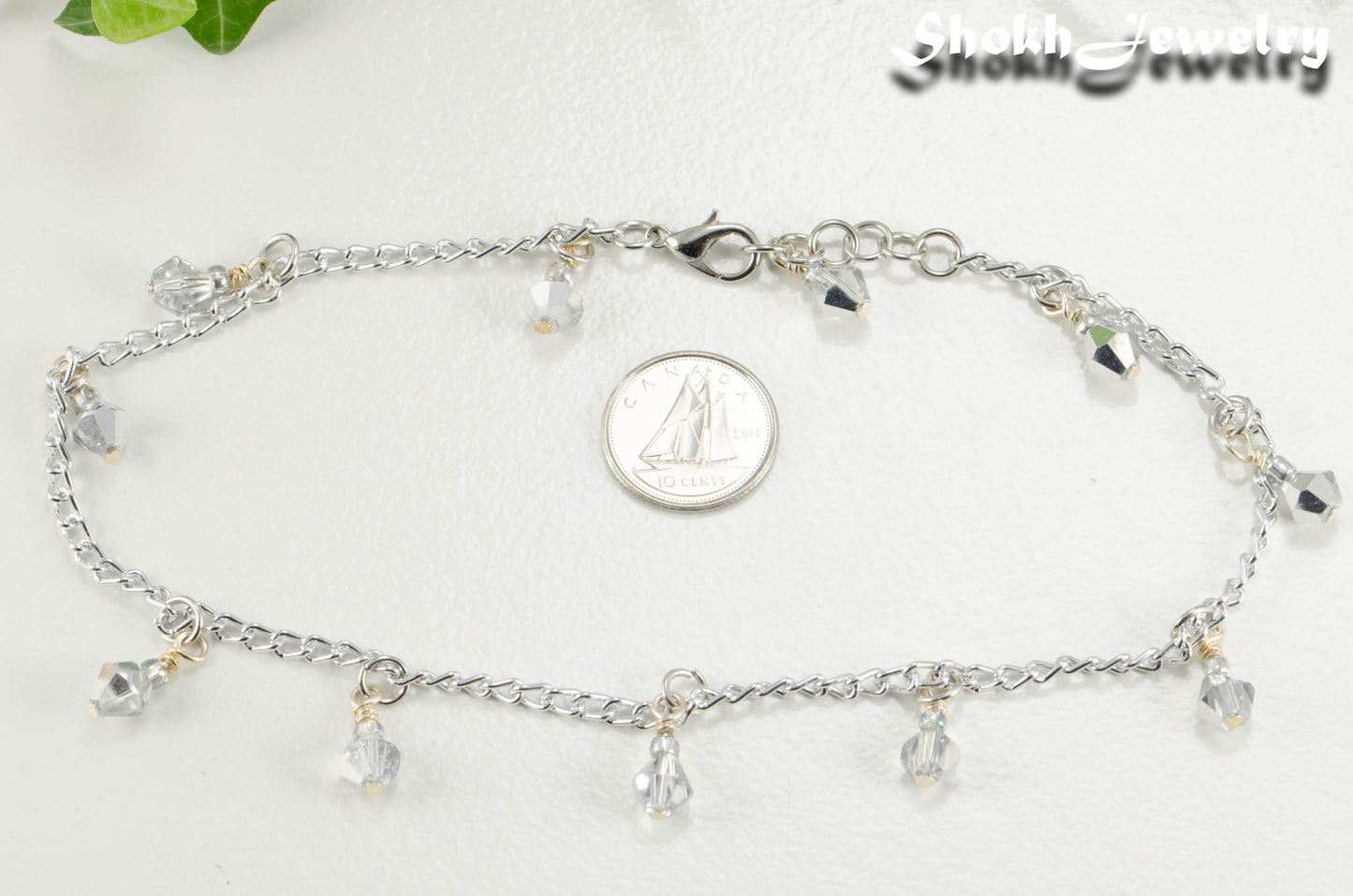 Sparkly Glass Crystal Dangle and Chain Anklet beside a dime.