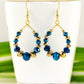 Blue and Gold Glass Crystal Hoop Earrings displayed on a tea cup.