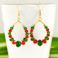 Close up of Green and Red Glass Crystal Hoop Earrings.