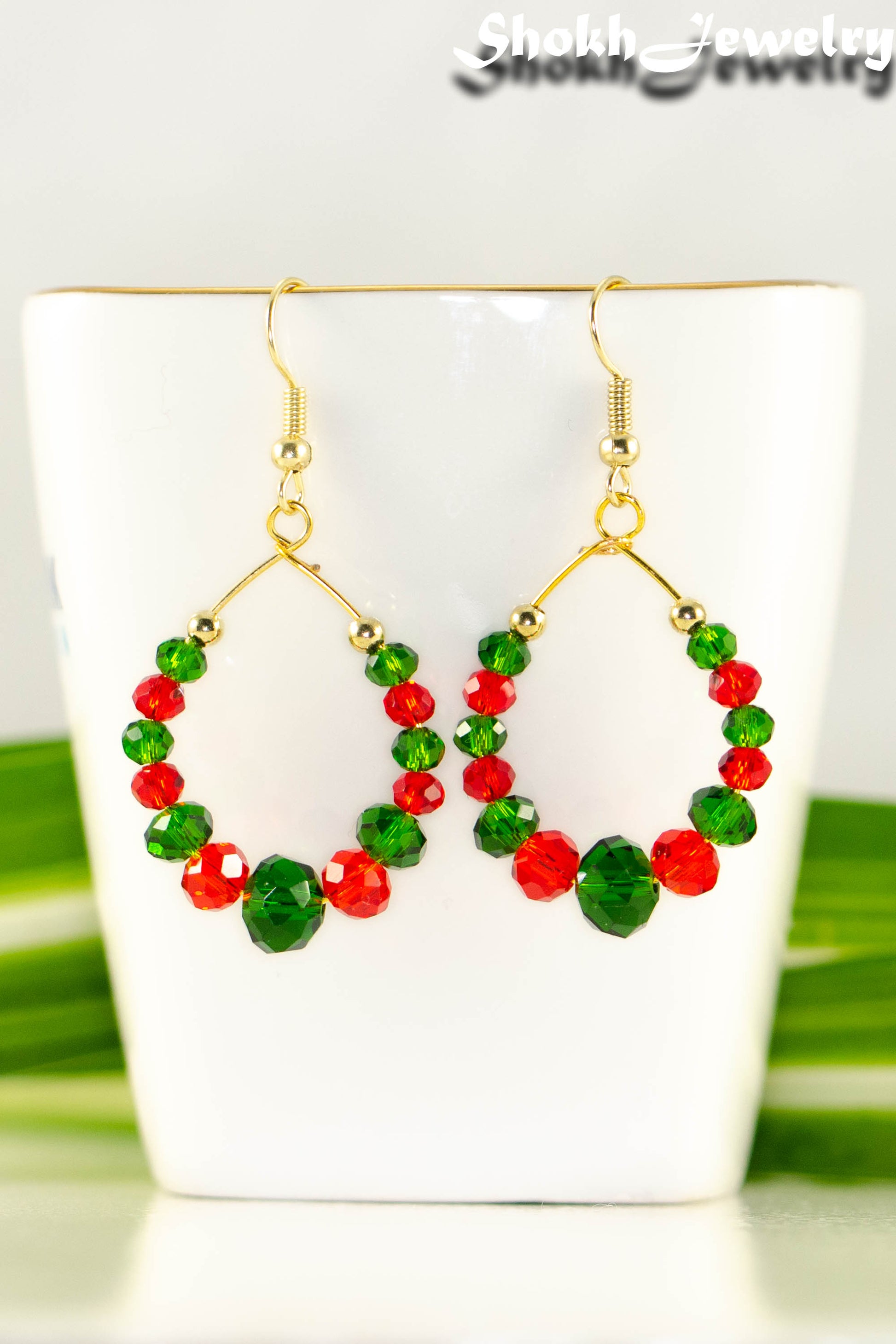 Close up of Green and Red Glass Crystal Hoop Earrings.