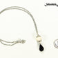 Lava Rock and Teardrop February Birthstone Choker Necklace beside a dime.