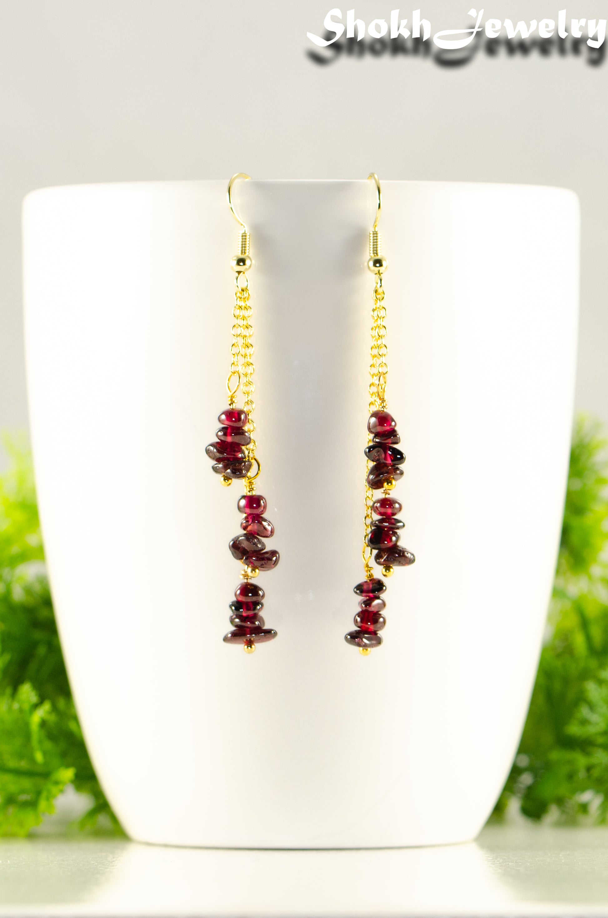 Close up of Long Gold Plated Chain and Garnet Crystal Chip Earrings.