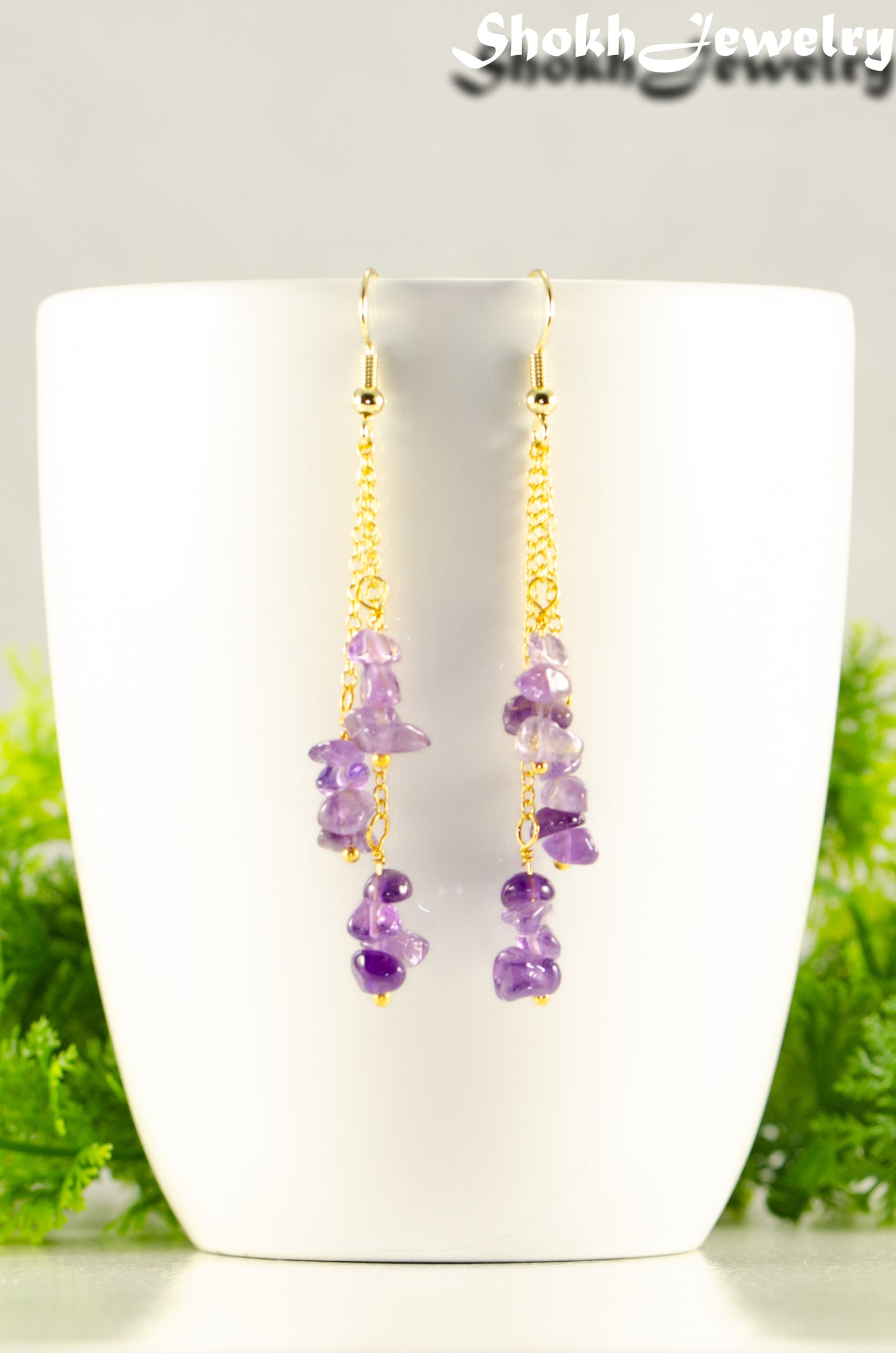 Close up of Long Gold Plated Chain and Amethyst Crystal Chip Earrings.