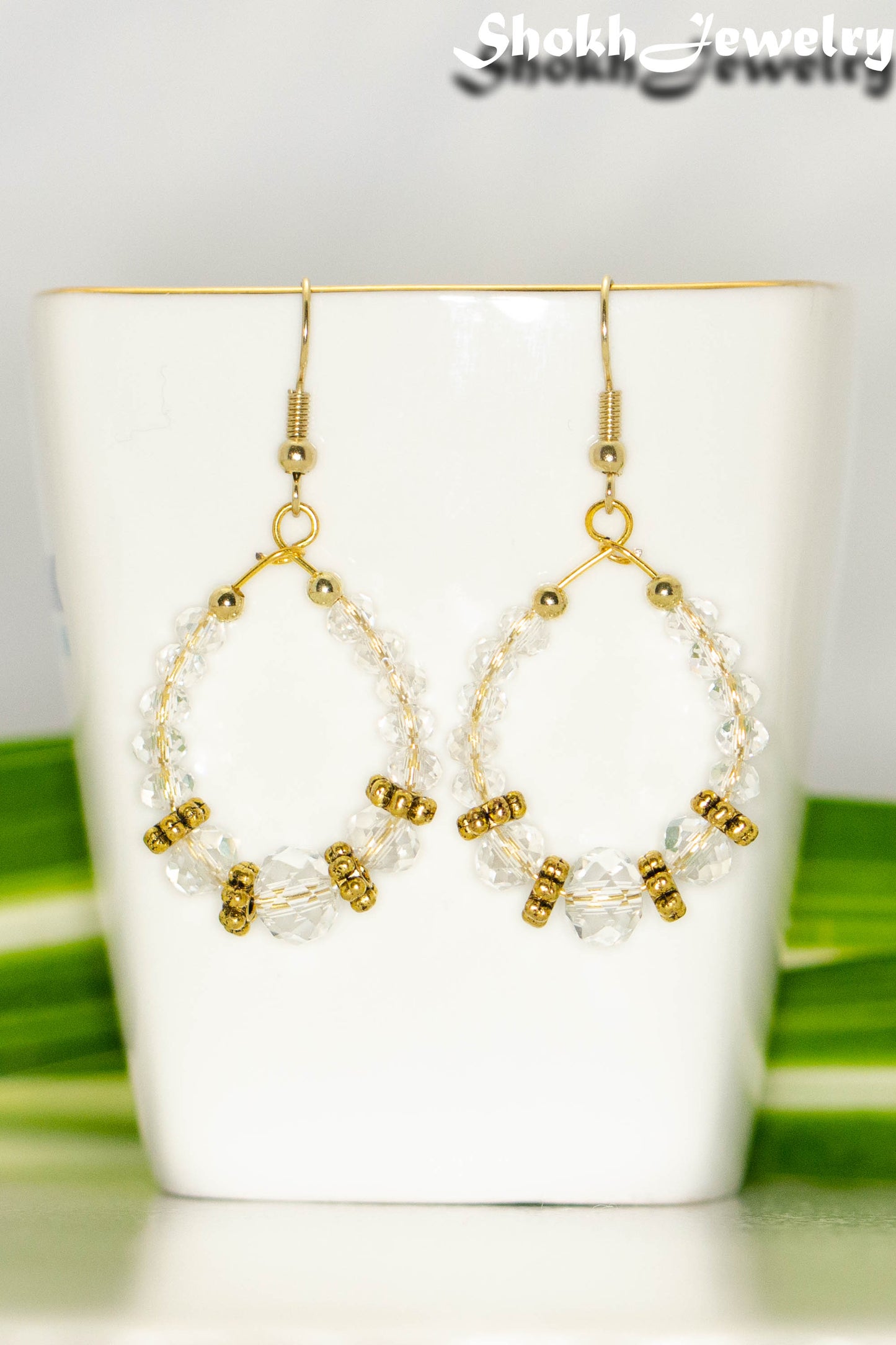 Close up of Clear Glass Crystal and Gold Hoop Earrings.