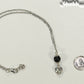 Lava Rock and Heart Shaped April Birthstone Choker Necklace beside a dime.