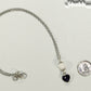 Lava Rock and Heart Shaped February Birthstone Choker Necklace beside a dime.