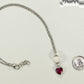 Lava Rock and Heart Shaped October Birthstone Choker Necklace beside a dime.