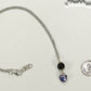 Lava Rock and Heart Shaped June Birthstone Choker Necklace beside a dime.