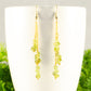 Close up of Long Gold Plated Chain and Peridot Chip Earrings.