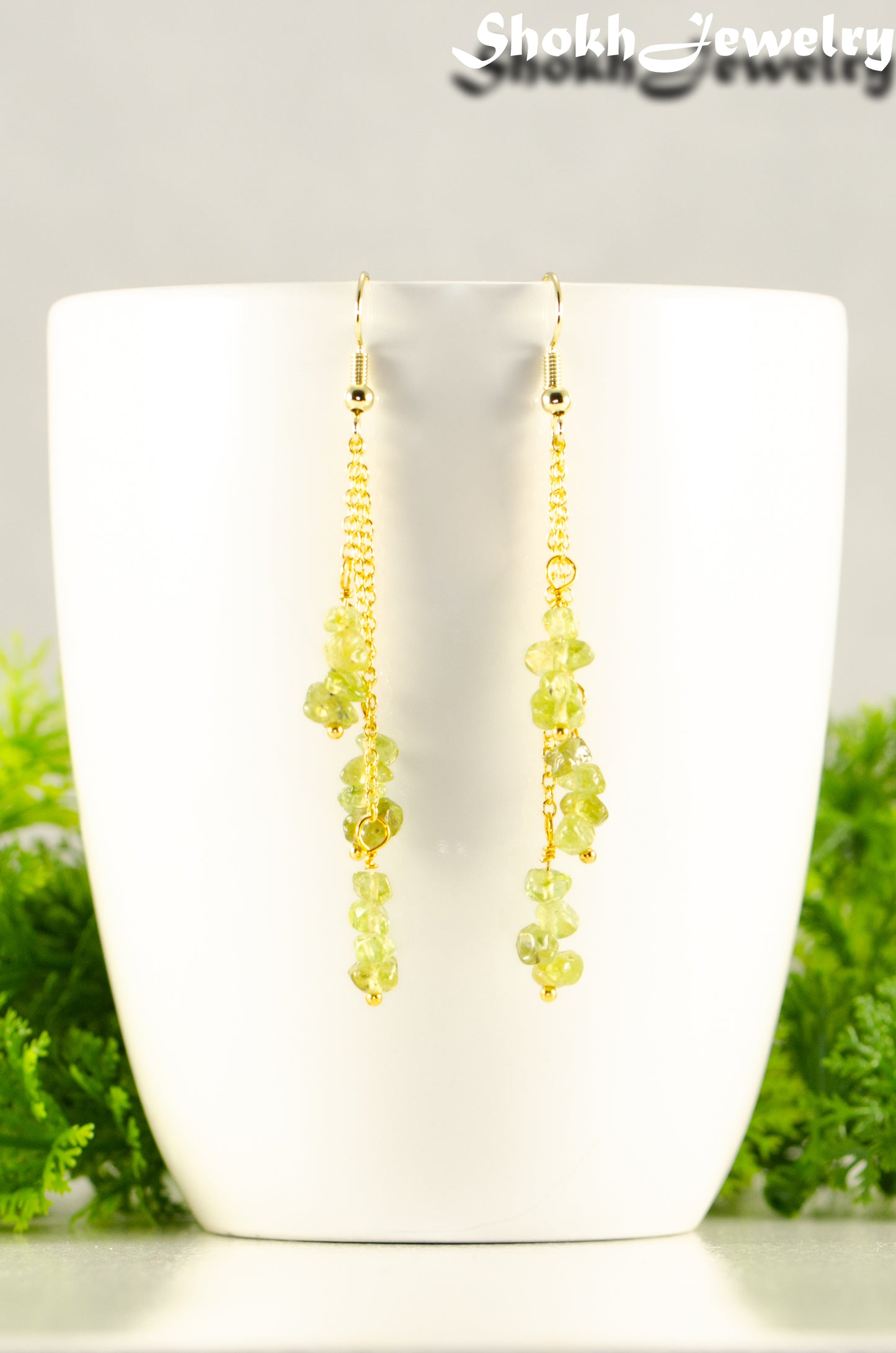 Close up of Long Gold Plated Chain and Peridot Chip Earrings.