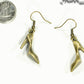 Antique Bronze High Heel Shoe Charm Earrings beside a dime.