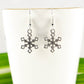 Close up of Christmas Snowflakes Charm Earrings.