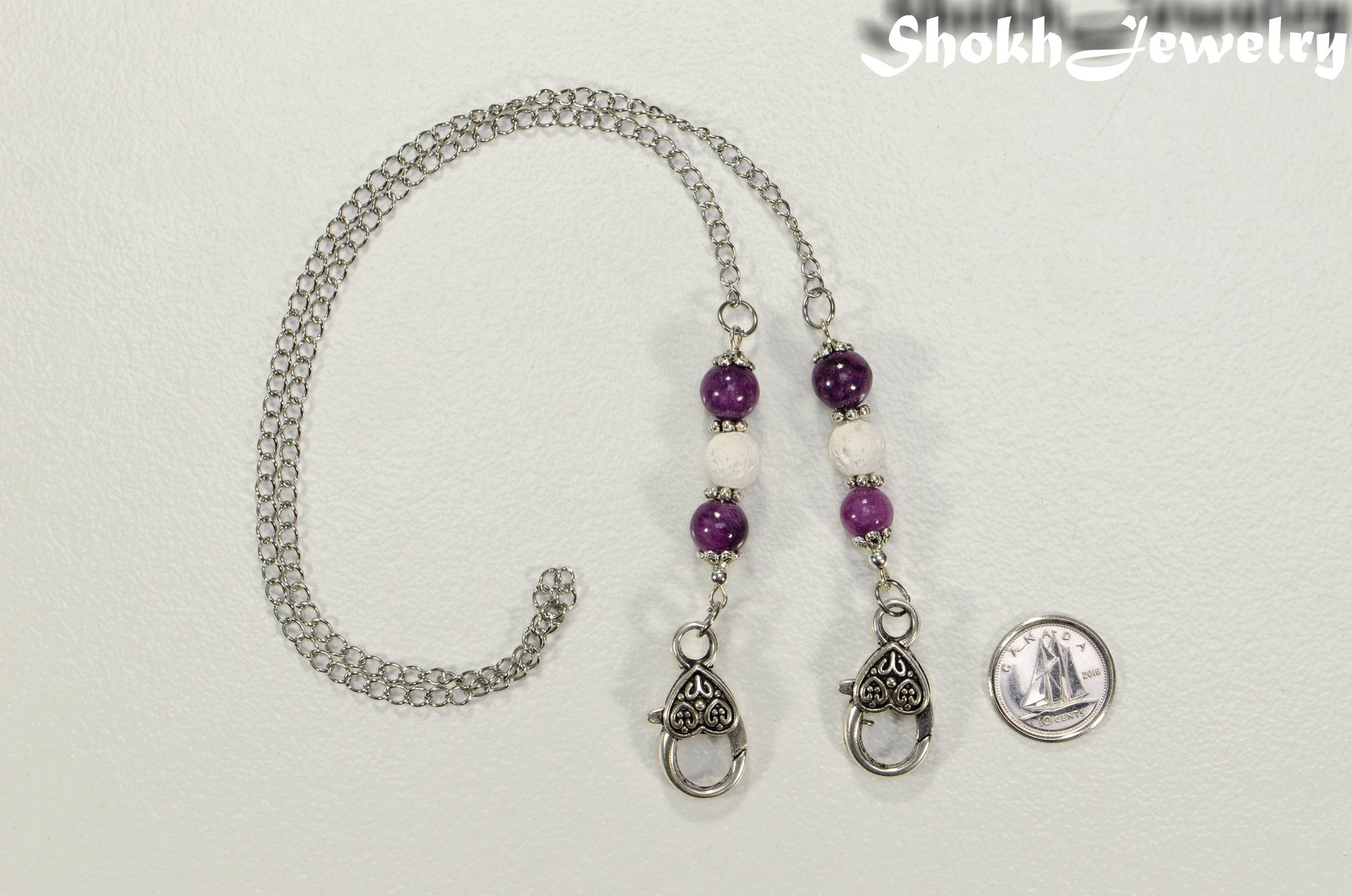 8mm Purple Quartzite and White Lava Stone Eyeglass Chain beside a dime.