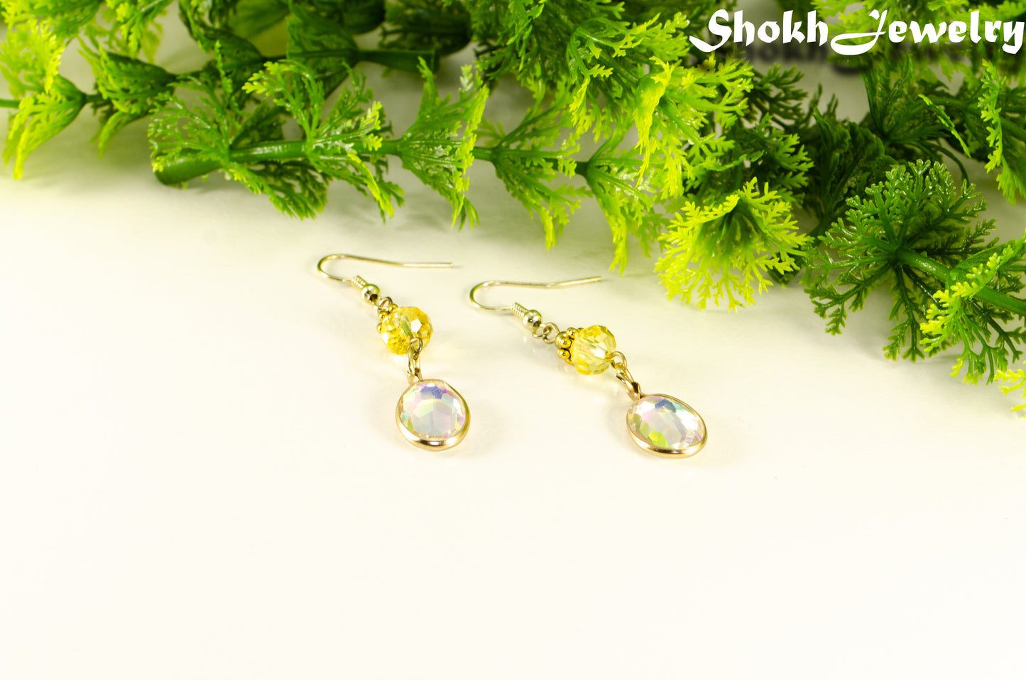 Light Yellow Oval Glass Dangle Earrings with gold tone ear wires.