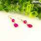 Hot Pink Oval Glass Dangle Earrings with gold tone ear wires.