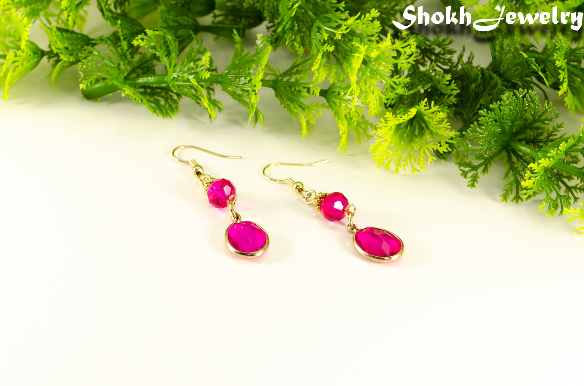 Hot Pink Oval Glass Dangle Earrings with gold tone ear wires.