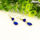 Navy Blue Oval Glass Dangle Earrings with gold tone ear wires.