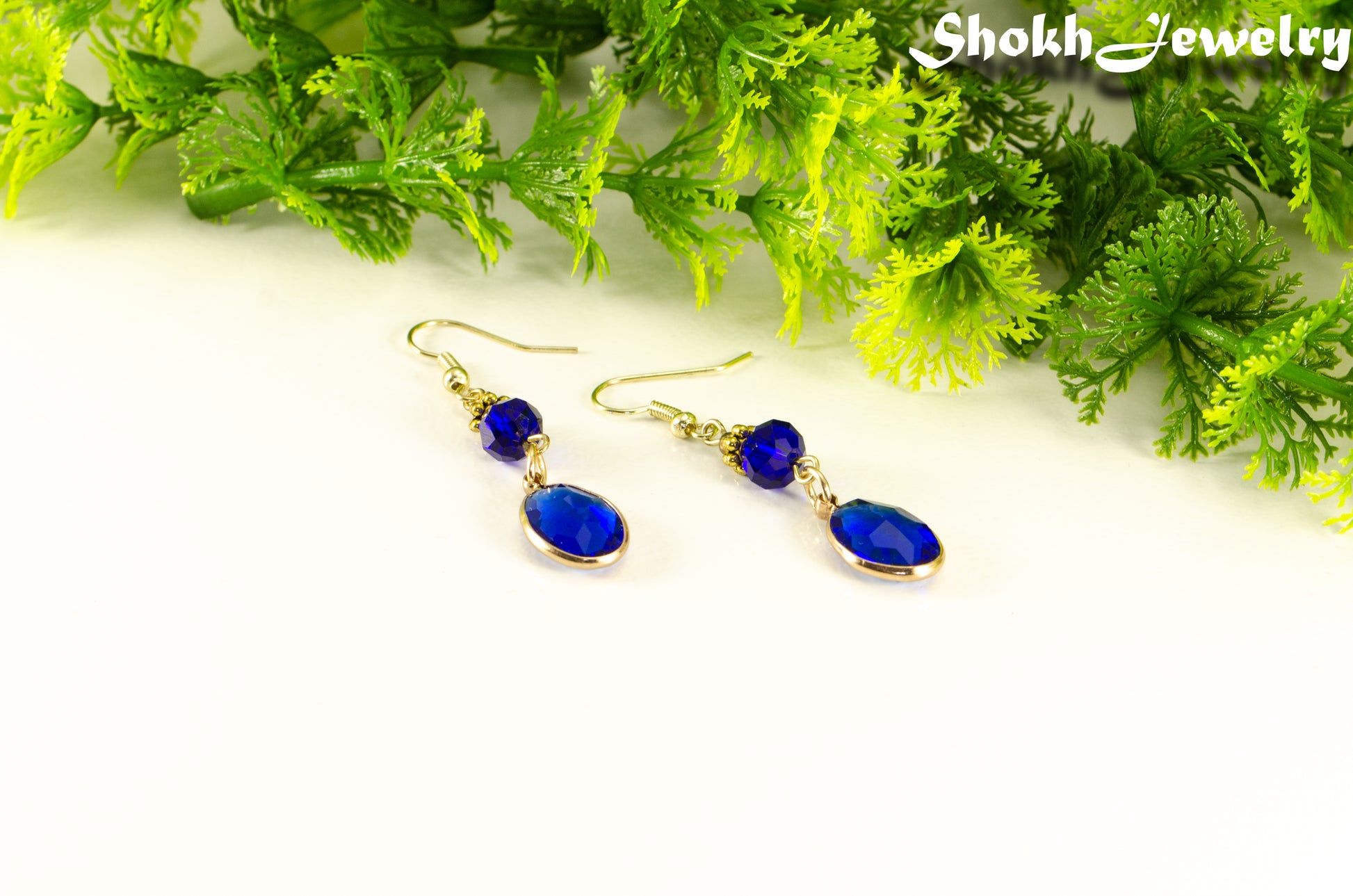 Navy Blue Oval Glass Dangle Earrings with gold tone ear wires.