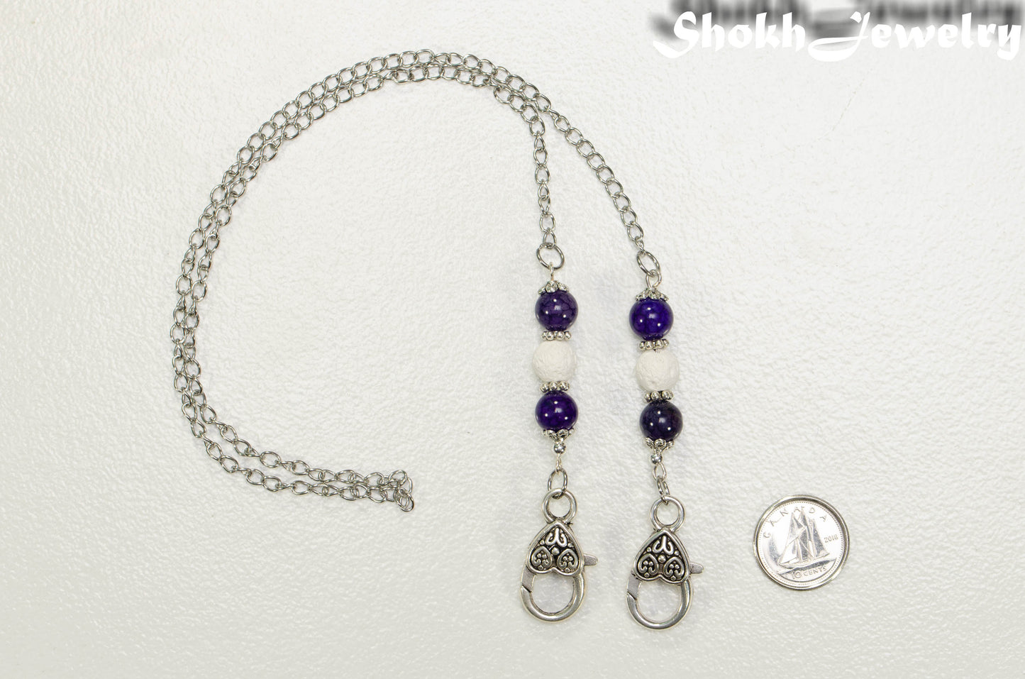 8mm Violet Agate and White Lava Stone Eyeglass Chain beside a dime.