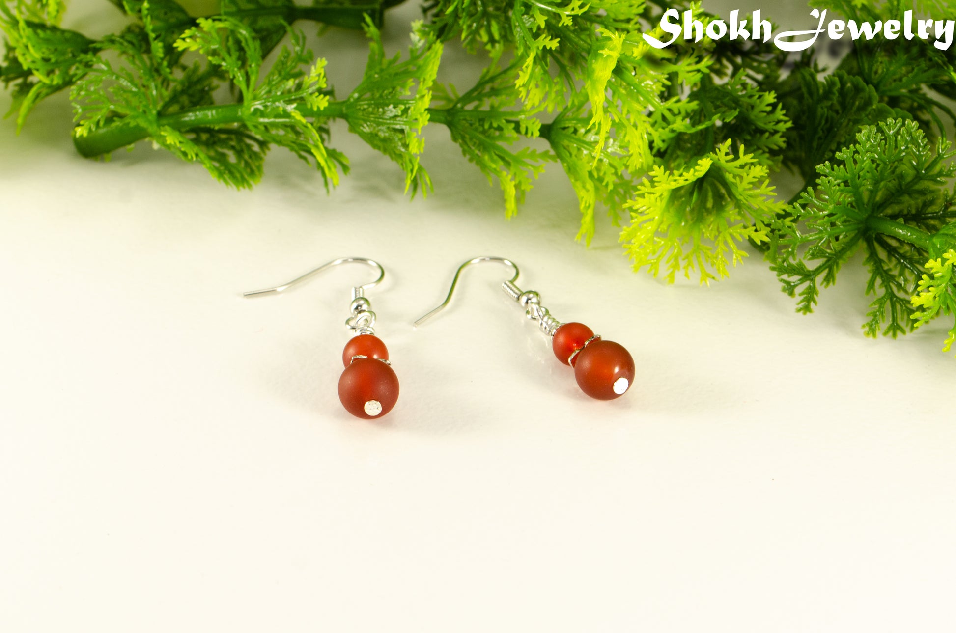 Small Matte Red Agate Earrings with silver tone ear wires.