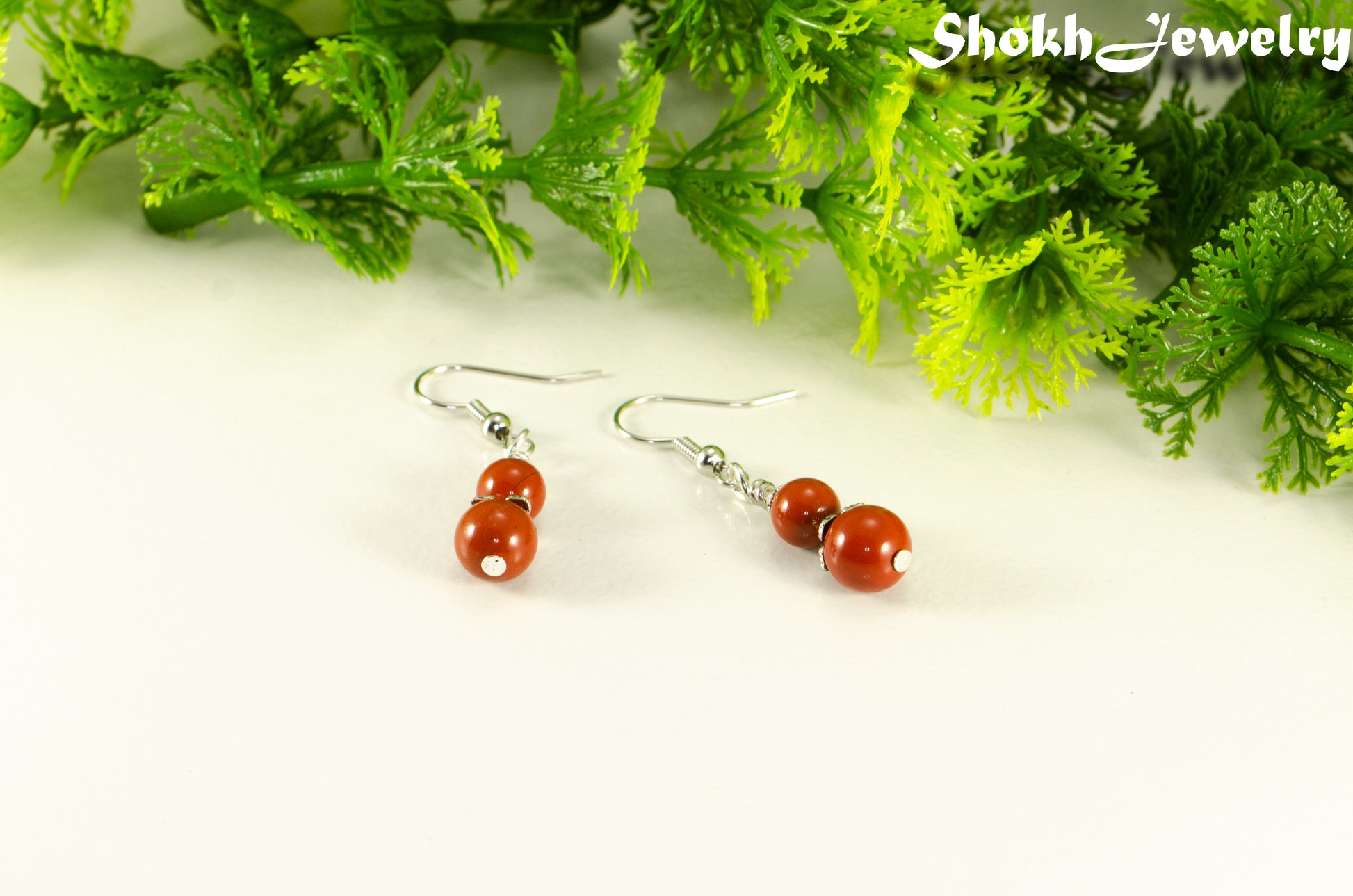 Small Natural Red Jasper Earrings with silver tone ear wires.