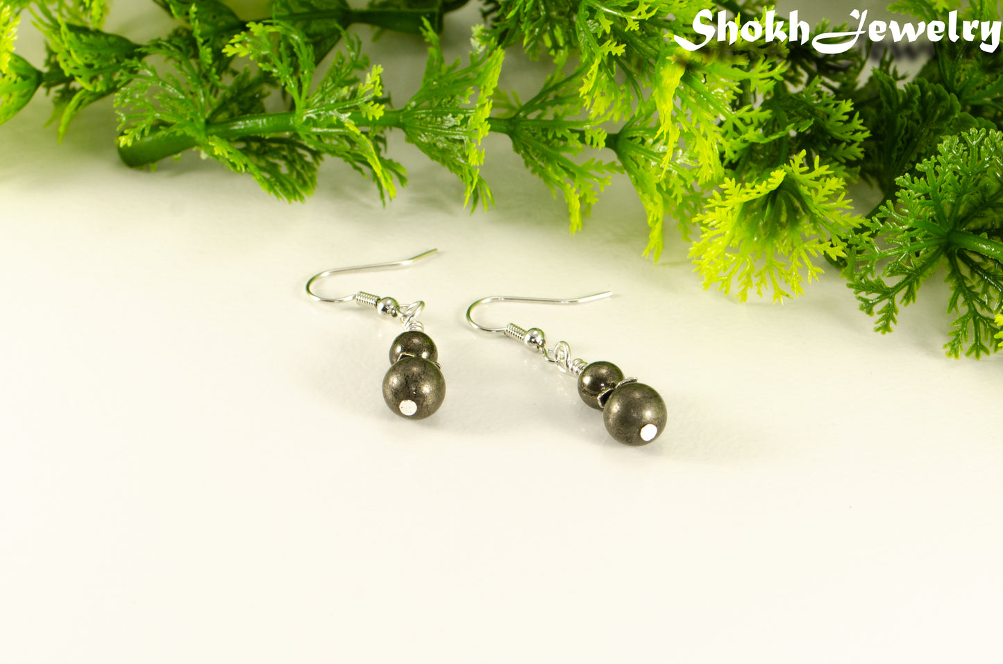 Small Natural Pyrite Earrings with silver tone ear wires.