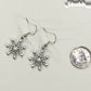 Christmas Snowflakes Charm Earrings beside a dime.