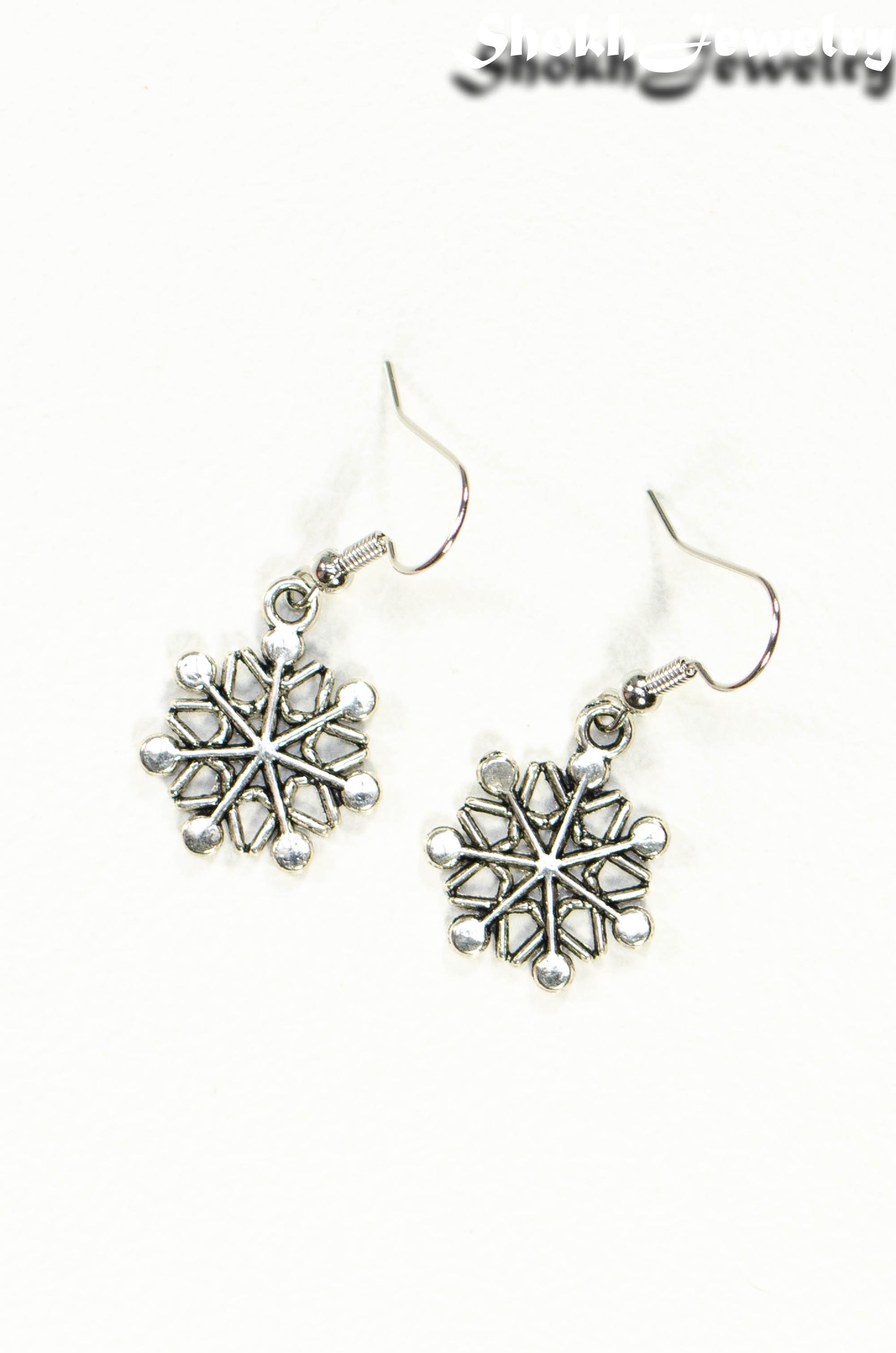 Top view of Christmas Snowflakes Charm Earrings.