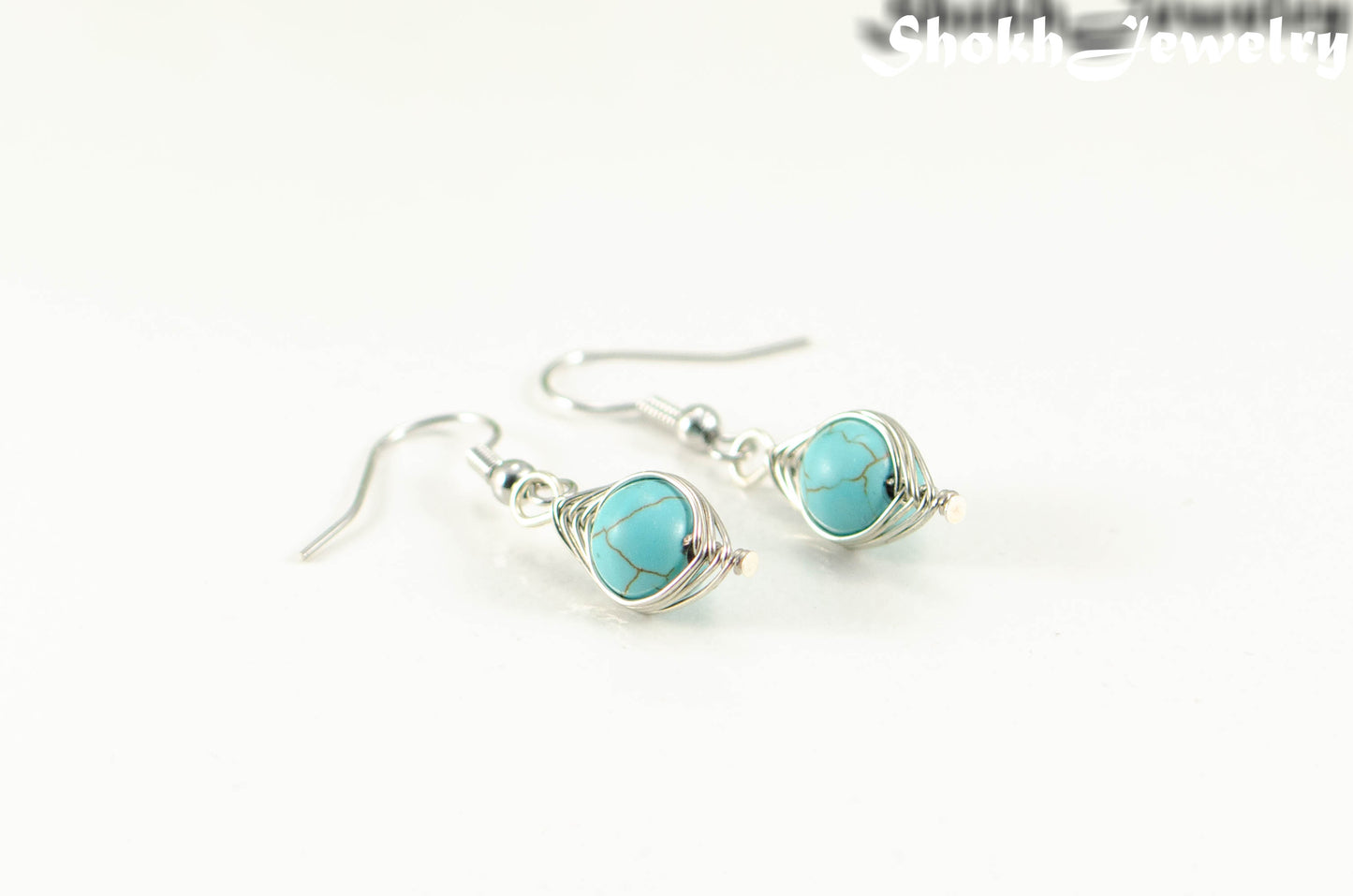 Turquoise Howlite Wire Wrapped Earrings with silver tone ear wires.