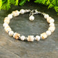 Close up of Freshwater Pearl and Seashell Bracelet with Clasp.