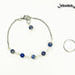 Lapis Lazuli and Stainless Steel Chain Bracelet beside a dime.