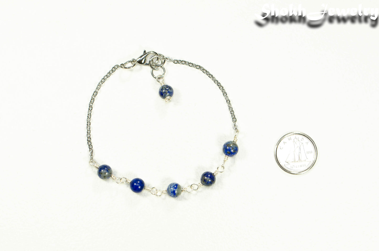 Lapis Lazuli and Stainless Steel Chain Bracelet beside a dime.