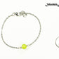 8mm Peridot and Chain Anklet beside a dime.