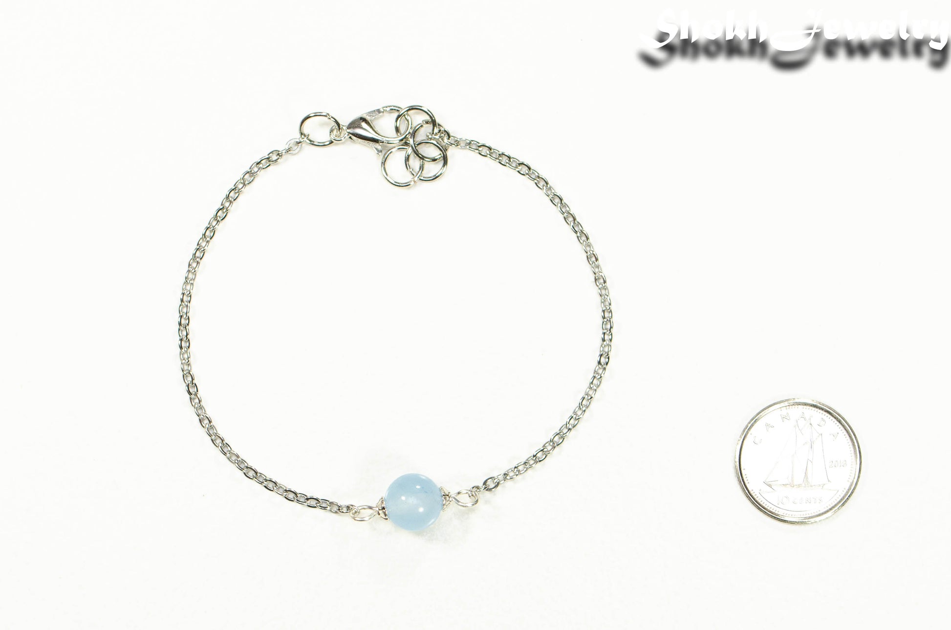 8mm Aquamarine and Chain Anklet beside a dime.