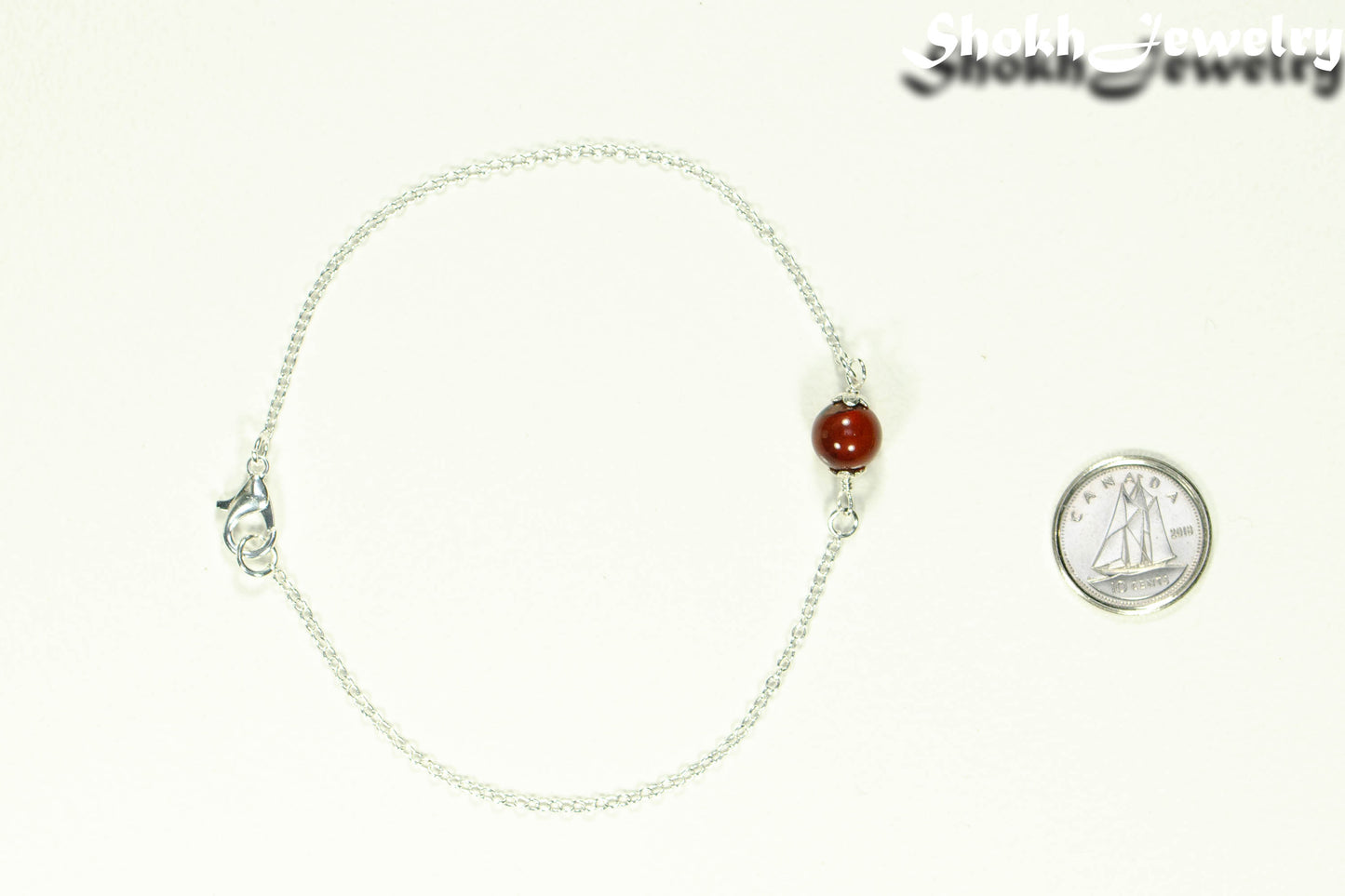 Minimal Carnelian Bracelet beside a dime.