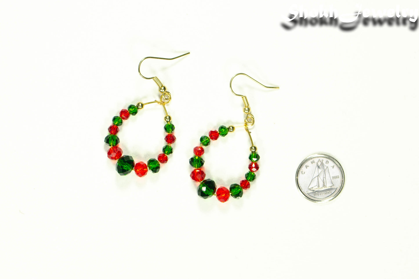 Green and Red Glass Crystal Hoop Earrings beside a dime.