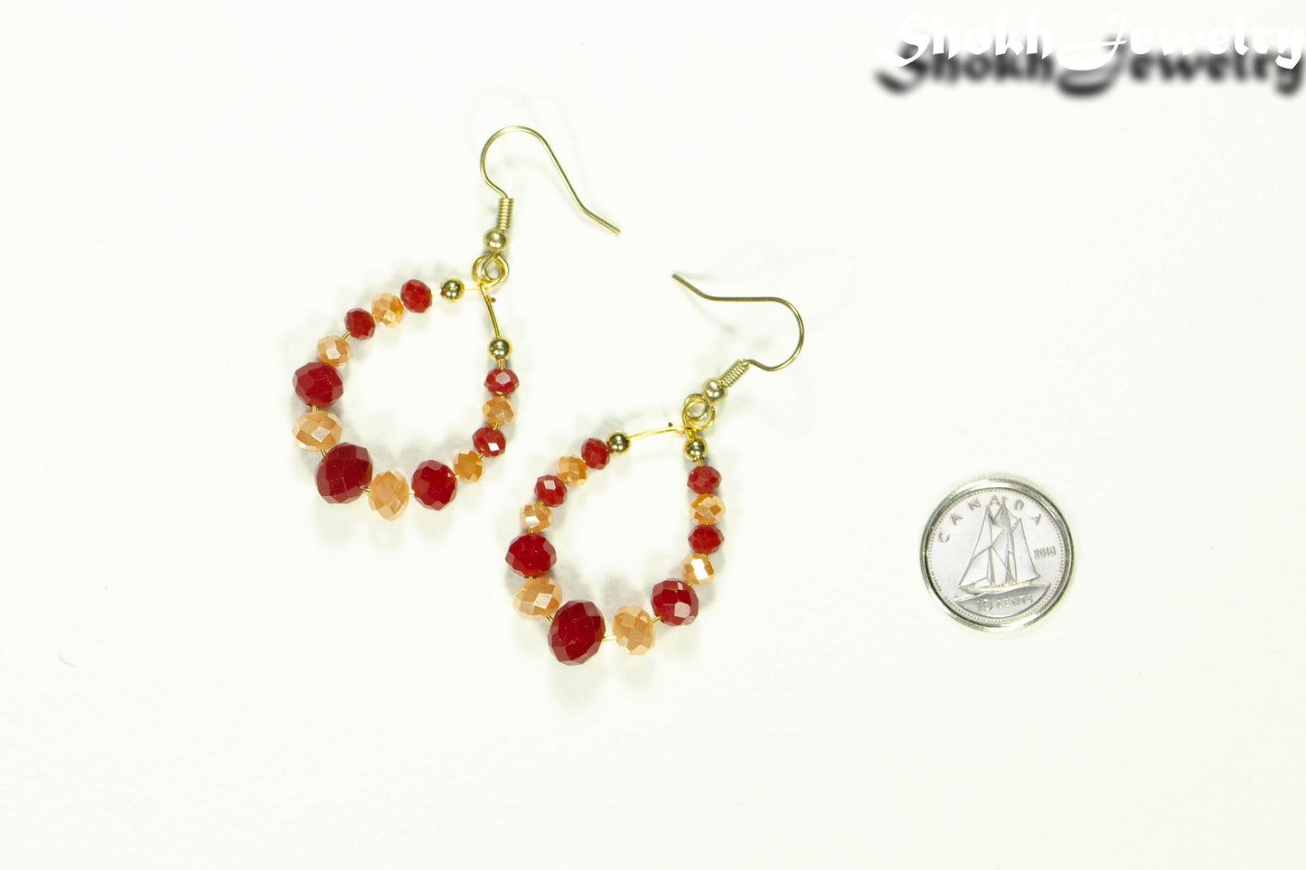 Red and Gold Glass Crystal Hoop Earrings beside a dime.