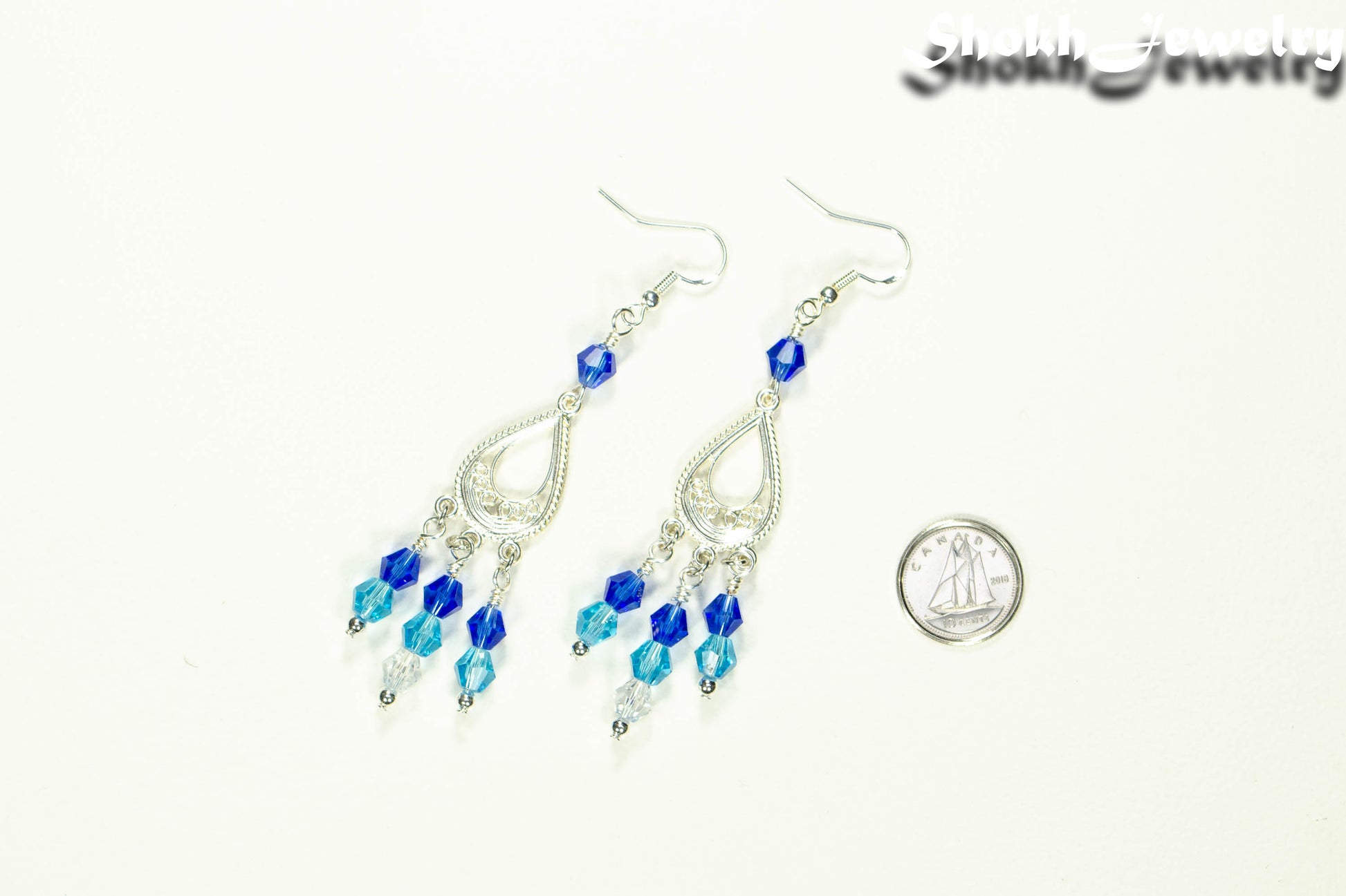 Ombre Blue Glass Crystal Chandelier Earrings beside a dime.