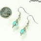 Turquoise Howlite Wire Wrapped Earrings beside a dime.