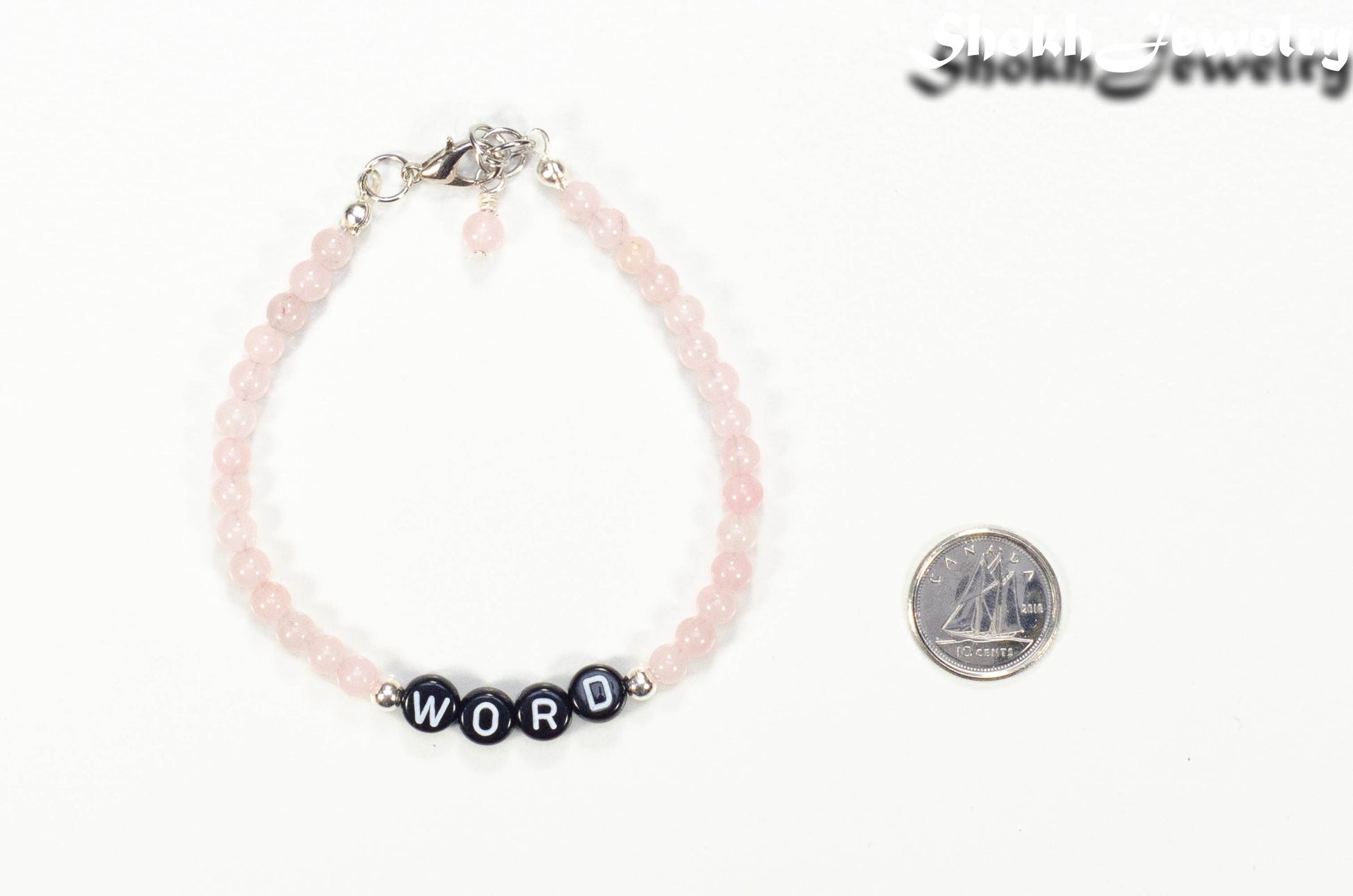 Personalized Rose Quartz Bracelet with Clasp beside a dime.