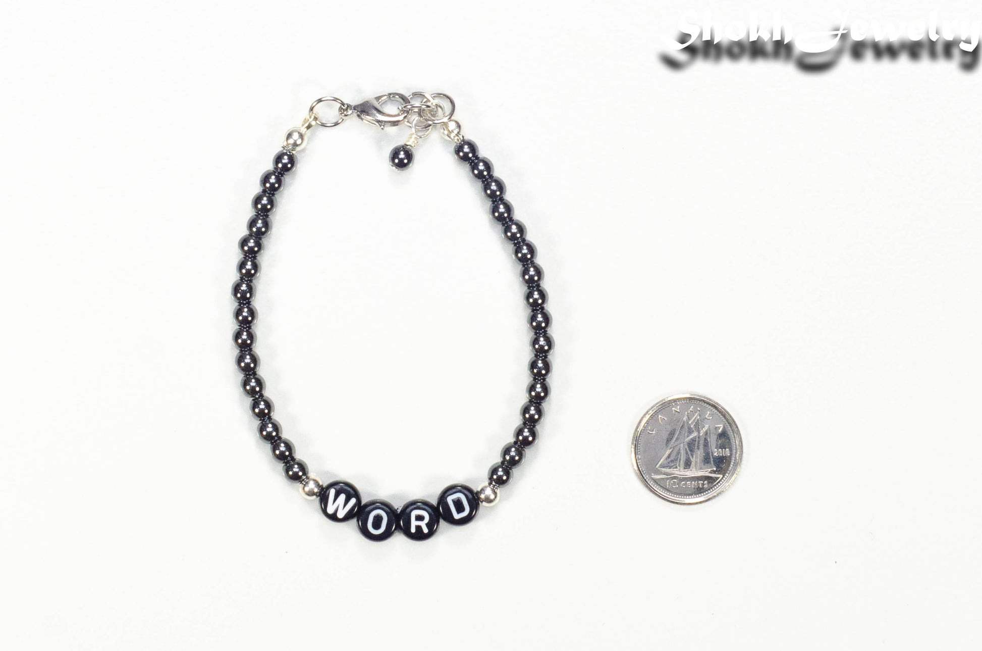 Personalized Hematite Stone Bracelet with Clasp beside a dime.