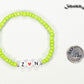 Lime Green Seed Beads Bracelet with Initials beside a dime.