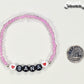 Pink Seed Beads Name Bracelet beside a dime.