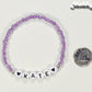 Purple Seed Beads Name Bracelet beside a dime.