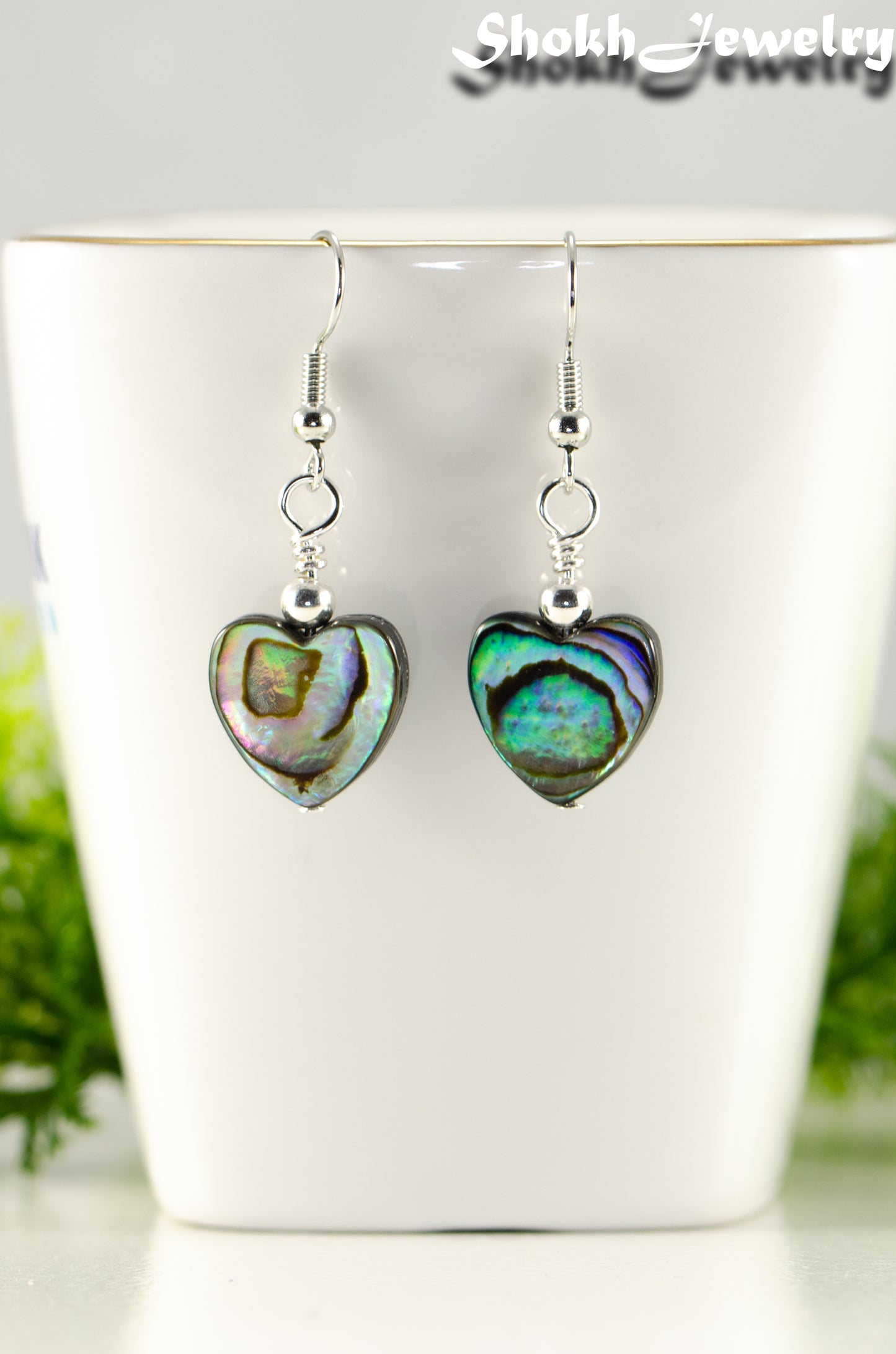 Close up of Heart Shaped Abalone Shell Earrings.