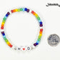 Rainbow seed beads Bracelet with Initials beside a dime.